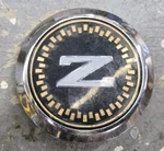 84-86 Nissan 300ZXT Z31 Oem Front Bumper Emblem 62090 01P00 (*broken Stud*). Fixed Price $68.00.