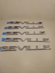 New Lot Of 5 Oem Gm Cadillac Seville Chrome Emblems Nos. Fixed Price $69.80.