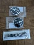Set Of Oem Genuine Nissan 350Z Emblems (two Round Rear Trunk One) New. Fixed Price $74.99.