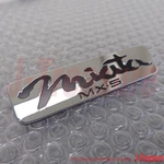 Mazda 99-05 Genuine Rear Emblem Black "MX-5 Miata" NC10-51-721B Oem. Fixed Price $54.00.
