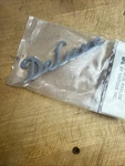 1939 Deluxe Ford Hood Side Emblem Stainless By Vintique. Fixed Price $10.00.