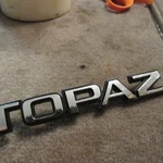 Nos 1984 1994 Mercury Topaz Trunk Decklid Nameplate Ford Emblem E86Y-5442528-A. Fixed Price $19.99.